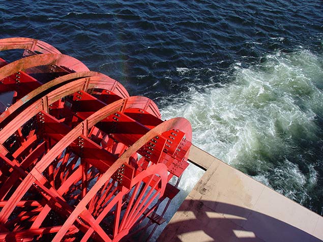 Water churning in the river from a boat's waterwheel