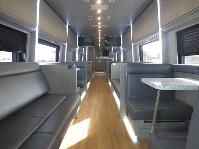 Interior of a Windstar Charter bus with tables and open windows