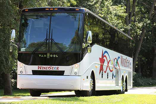 Windstar Bus parked near some trees in the sun