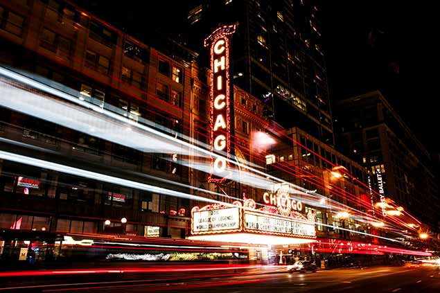 Bright Chicago Street at night with neon Chicago signs