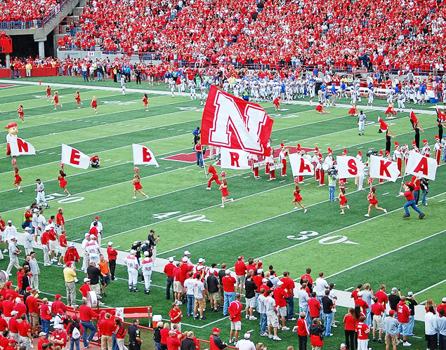 Nebraska Cornhuskers field with cheerleaders on the field